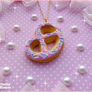 Sweet Pretzel Donut Necklace close-up showing pink glaze, pastel sprinkles and the textured pretzel pendant