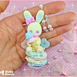 Bunny Pancakes Ice Cream Necklace held in a hand, showing the pastel bunny, ice cream cone and rainbow pancake details — view 2
